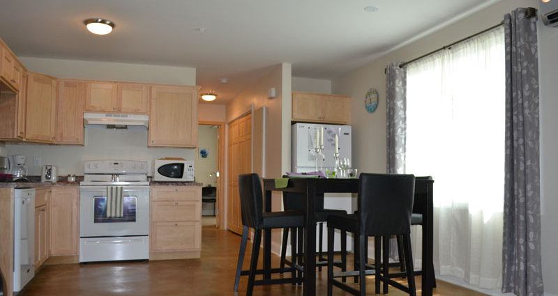 A kitchen with a table and chairs in it