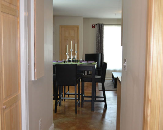 A dining room with a table and chairs