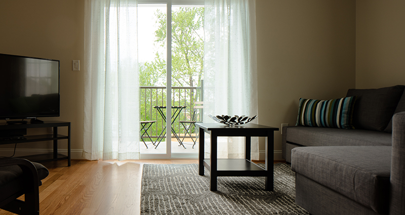 A living room with a table and chairs in it